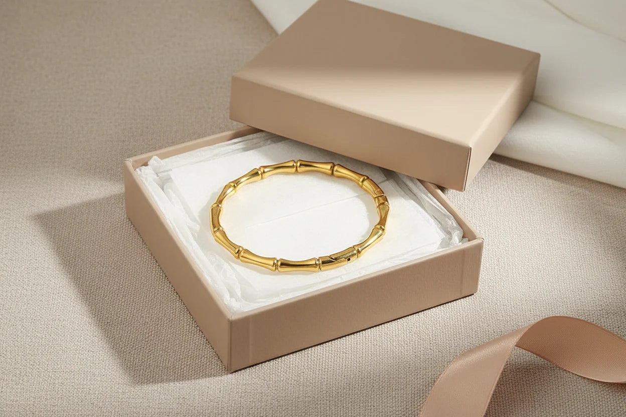 Gift-ready gold Bamboo bangle Bracelet presented in an open beige jewelry box with tissue paper and ribbon, styled as a luxurious present for someone special | Oria Jewel