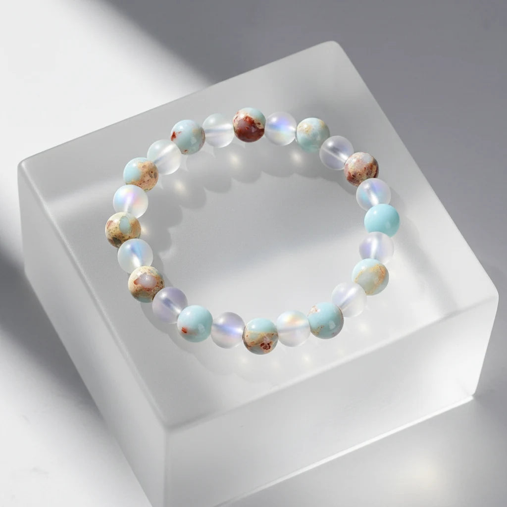 Minimal studio shot of the Luck & Health Stone Bracelet displayed on a frosted acrylic block, with soft shadows emphasizing the glossy round beads | Oria Jewel
