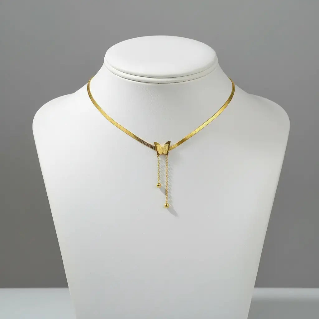 White display bust presenting refined gold variant of Silver Butterfly Chain Necklace against simple grey background | Oria Jewel