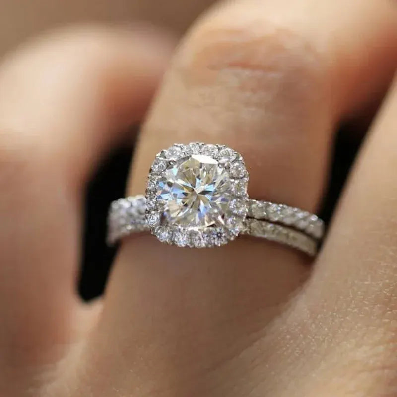 Soft Shine Halo Ring macro close-up on the finger, highlighting the brilliant round center, cushion-style halo outline, and shimmering pavé stones along the stacked band | OriaJewel