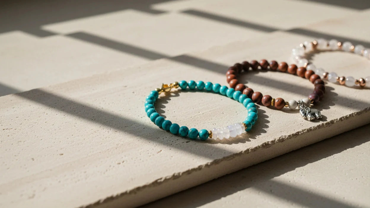 Sunlit flat lay of turquoise, wood, and pearl Beaded & Gemstone Bracelets Hero image on a textured stone surface | OriaJewel