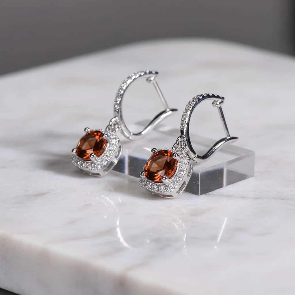 Amber Orange Drop Huggie Earrings on marble block with silver sparkle | OriaJewel