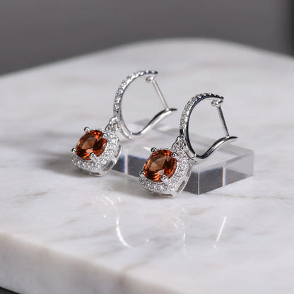 Amber Orange Drop Huggie Earrings on marble block with silver sparkle | OriaJewel