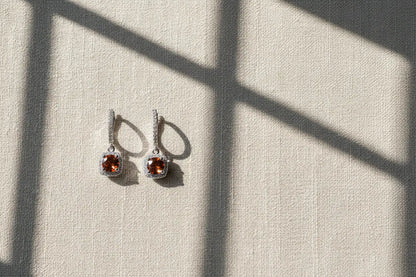 Amber Orange Drop Huggie Earrings on linen with window shadow | OriaJewel