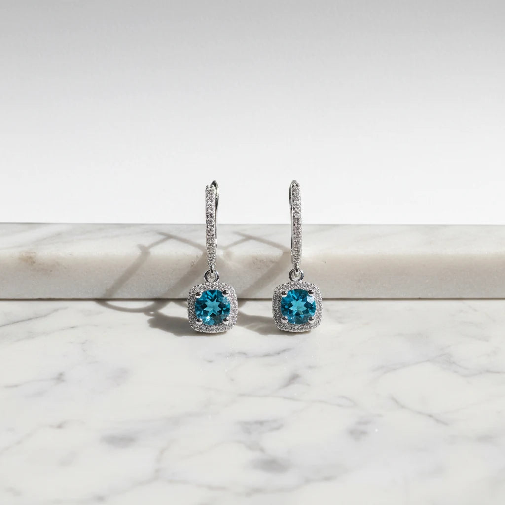Aqua Blue Drop Huggie Earrings front close-up on marble ledge with halo drops | OriaJewel