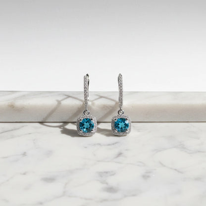 Aqua Blue Drop Huggie Earrings front close-up on marble ledge with halo drops | OriaJewel