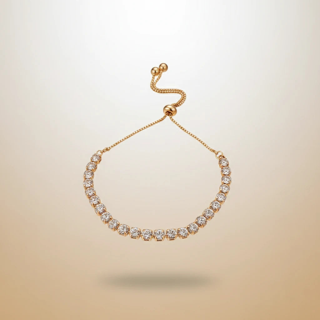 Floating gold Aurelia Cluster Tennis Bracelet centered on a soft beige gradient background, showcasing the full curved line of clustered crystals in focus | Oria Jewel