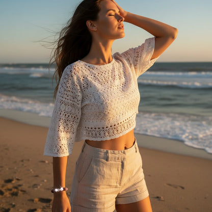 Woman walking along the beach at golden hour, eyes closed in the breeze, wearing the shimmering Aurora Healing Crystal Bracelet | Oria Jewel