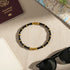 Flat lay of Black Bamboo bangle Bracelet arranged with passport, city map, and black sunglasses, styled as an elegant travel accessory in natural light | Oria Jewel