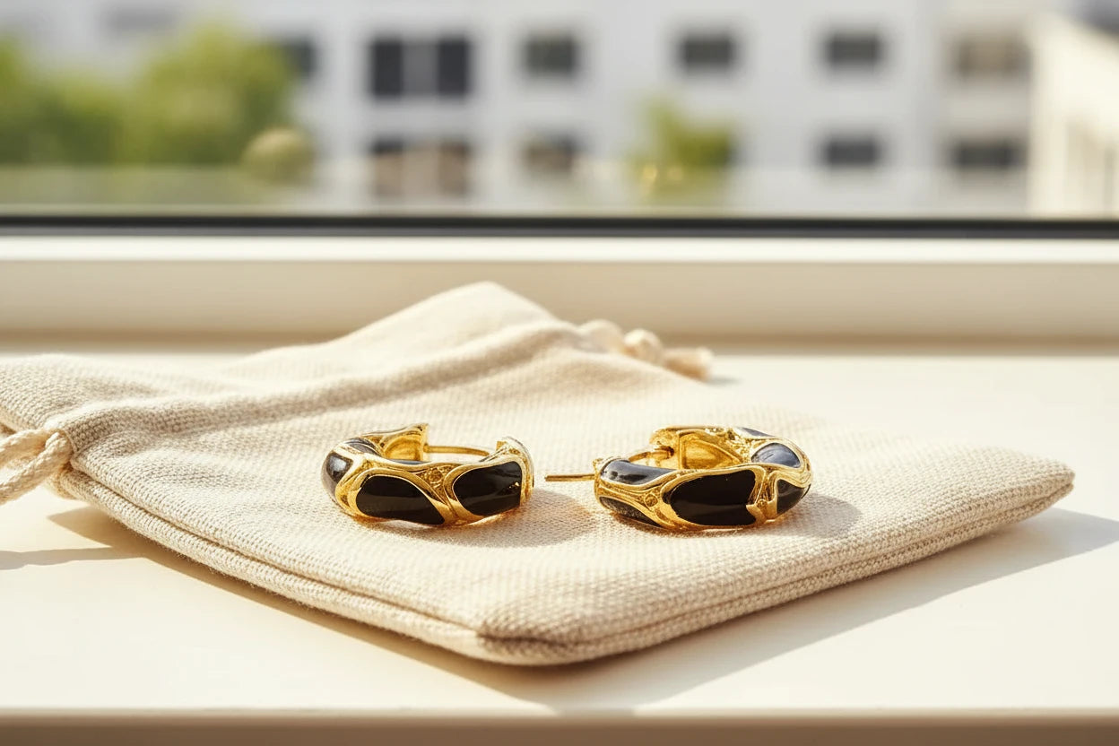 Black Huggie Hoop Earrings on pouch in window light close-up | OriaJewel