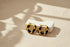 Black Huggie Hoop Earrings on textured fabric with soft shadow | OriaJewel