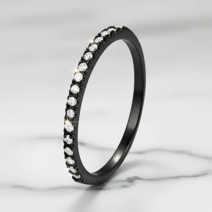 Black Midi Ring Set featured in a close-up product shot, the black pavé band standing upright on a light marble surface with crisp focus on the glittering stone row and subtle studio sparkle highlights | OriaJewel