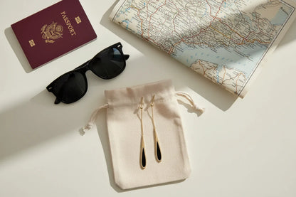 Black Teardrop Chain Drop Earrings travel flat lay with passport and map | OriaJewel