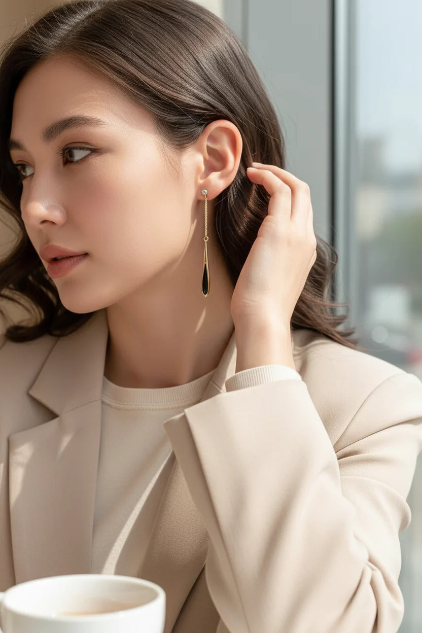 Black Teardrop Chain Drop Earrings on model in cozy library close-up | OriaJewel