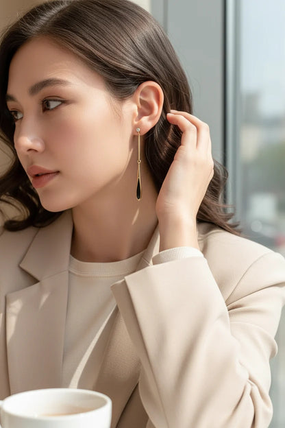 Black Teardrop Chain Drop Earrings on model in cozy library close-up | OriaJewel