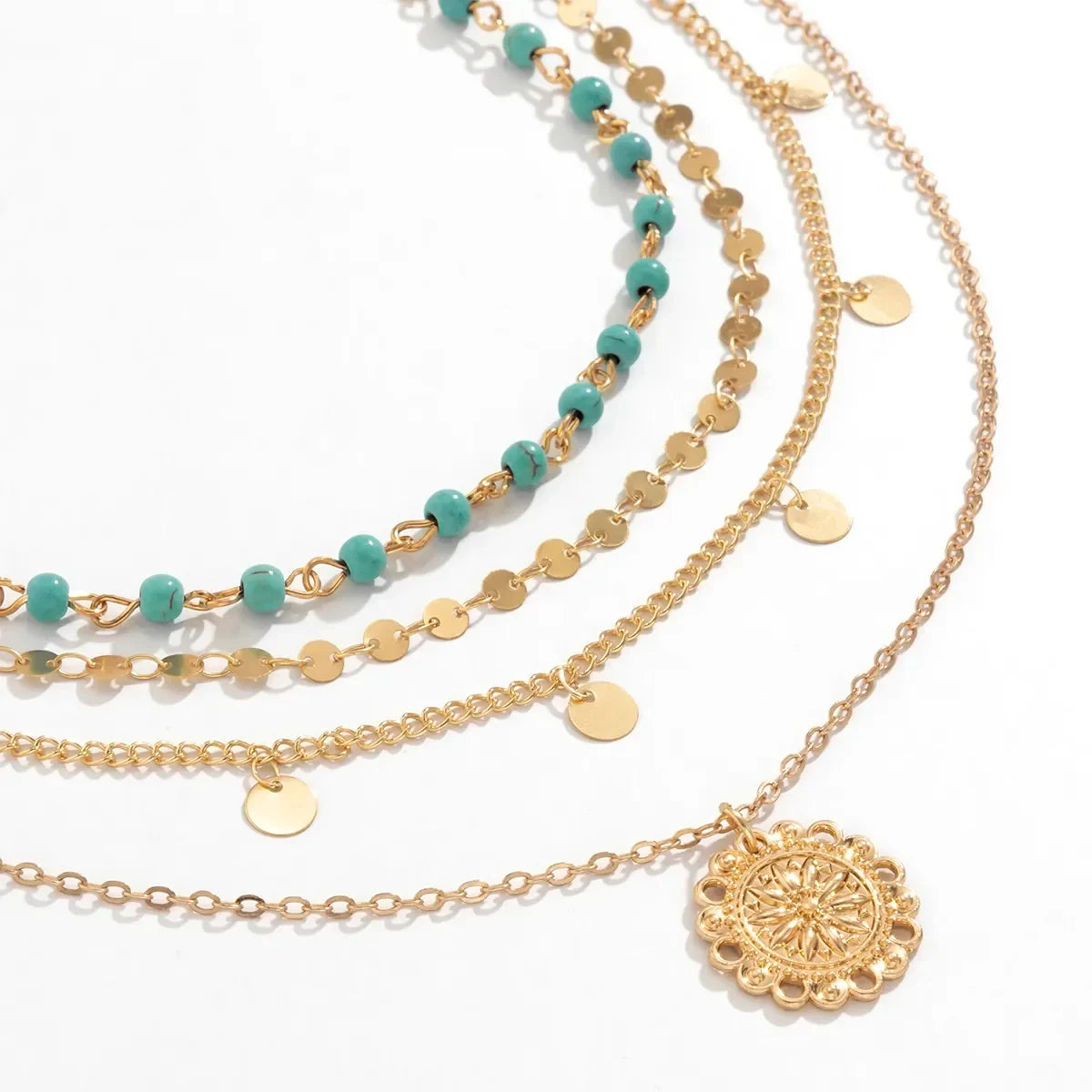 Close-up of the Boho Pendant Necklace Set featuring gold chains, turquoise beads, and a round medallion pendant | Oria Jewel