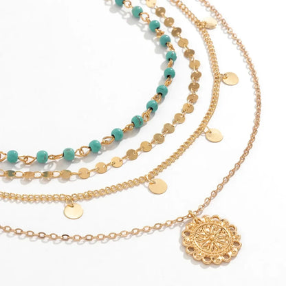 Close-up of the Boho Pendant Necklace Set featuring gold chains, turquoise beads, and a round medallion pendant | Oria Jewel