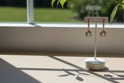 Bronze Crystal Drop Huggie Earrings on display stand by window light with plant | OriaJewel