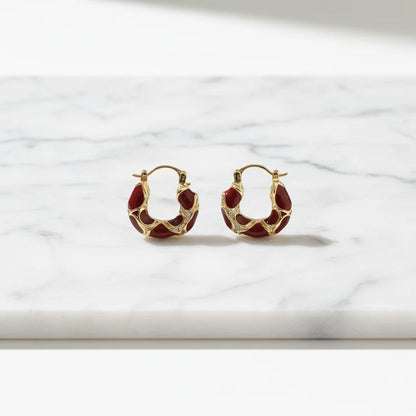 Burgundy Huggie Hoop Earrings close-up on marble background | OriaJewel