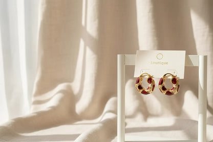 Burgundy Red Huggie Hoop Earrings on display stand with soft fabric light | OriaJewel