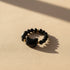 Black faceted bead Cat Charm Ring, gold accents, on sunlit beige | Oria Jewel