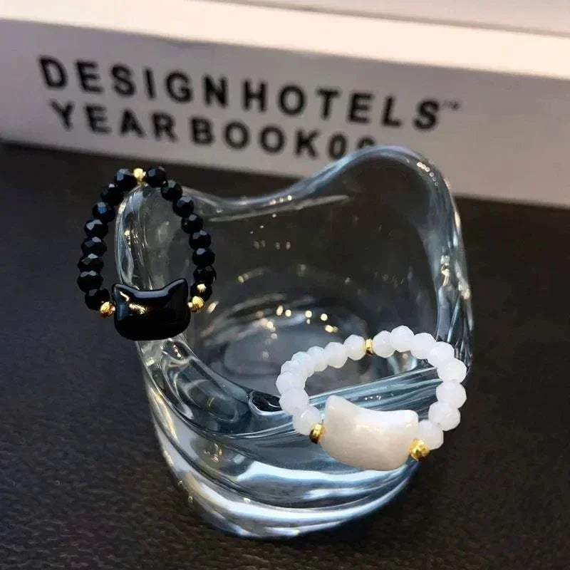 Two elegant Cat Charm Rings, black and white beaded, in clear glass | Oria Jewel