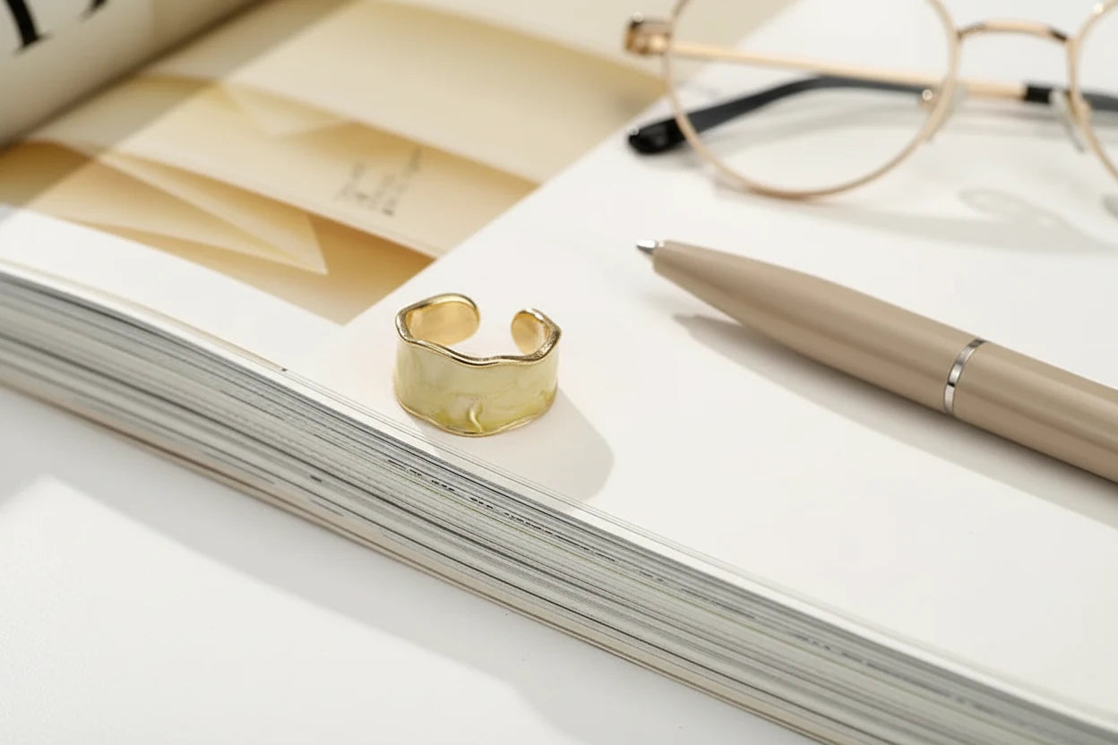Champagne Marble Open Wave Ring styled on an open magazine beside a pen and glasses | OriaJewel
