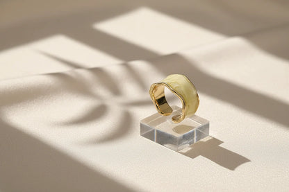 Champagne Marble Open Wave Ring on a clear acrylic stand with window-light shadows | OriaJewel