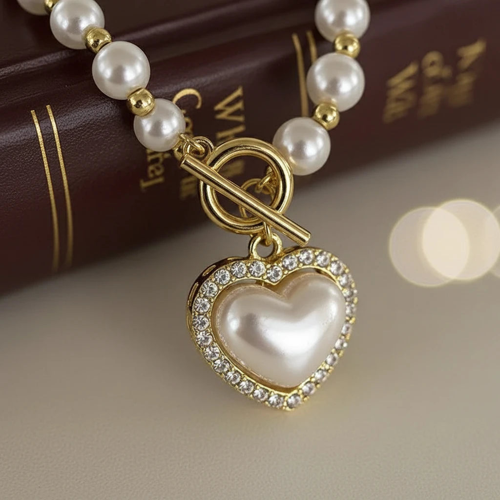Close-up of Chanel Pearl Heart Necklace showing detailed pearl heart pendant with sparkling crystal border and gold clasp | Oria Jewel