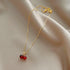 Close-up of Cherry Pendant Necklace showing detailed twin red gemstone cherries with crystal-studded leaf on gold chain | Oria Jewel