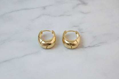 Chunky Gold Huggie Hoop Earrings close-up pair on marble background | OriaJewel