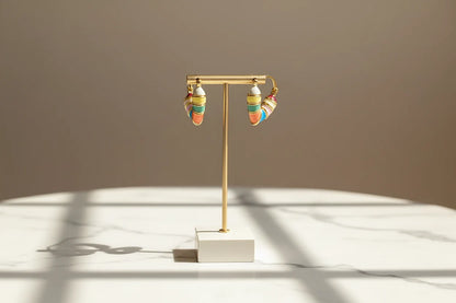 Colorful Heart Huggie Hoop Earrings on gold stand with soft shadows | OriaJewel