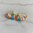 Colorful Heart Huggie Hoop Earrings close-up on marble surface | OriaJewel