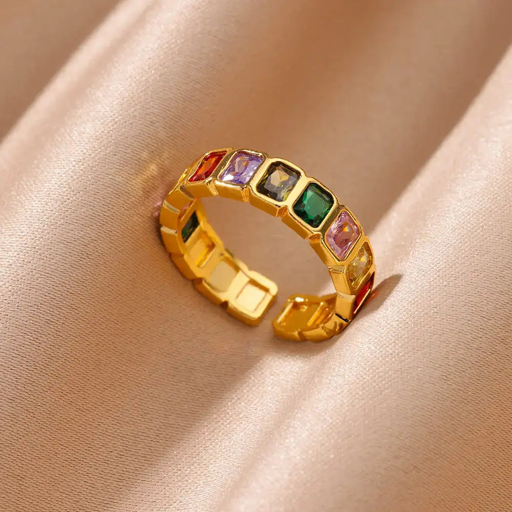 Close-up of Colorful stone band ring with rainbow rectangular stones on soft beige satin fabric | OriaJewel