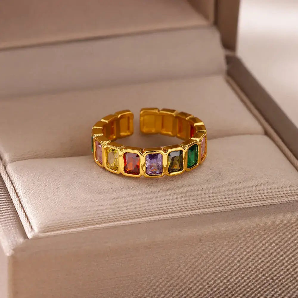 Open jewelry box display featuring a Colorful stone band ring with assorted colored stones in a gold setting | OriaJewel