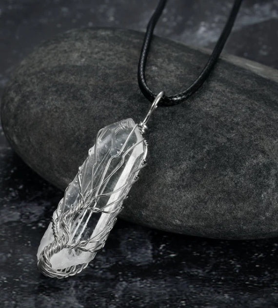 close-up of shiny crystal stone pendant reflecting light | Oria Jewel