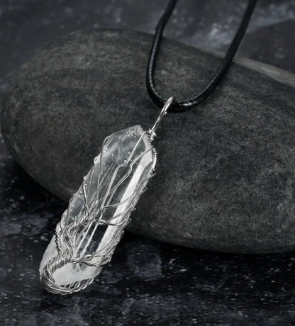 close-up of shiny crystal stone pendant reflecting light | Oria Jewel