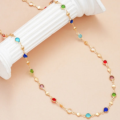 Crystal Y Necklace featuring colorful gemstones set in gold-tone chain on a stylish display | Oria Jewel
