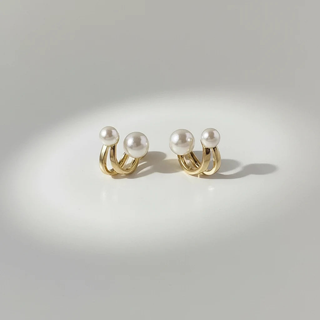 Double Pearl Huggie Hoop Earrings pair on soft spotlight background | OriaJewel