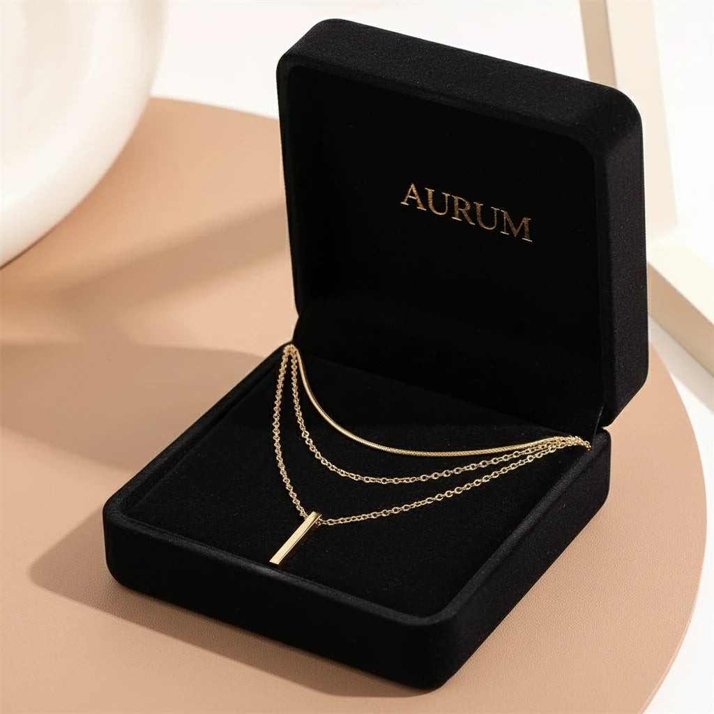 Drop Bar Pendant Necklace in gold displayed inside a luxurious black velvet jewelry box with elegant gold logo text | Oria Jewel