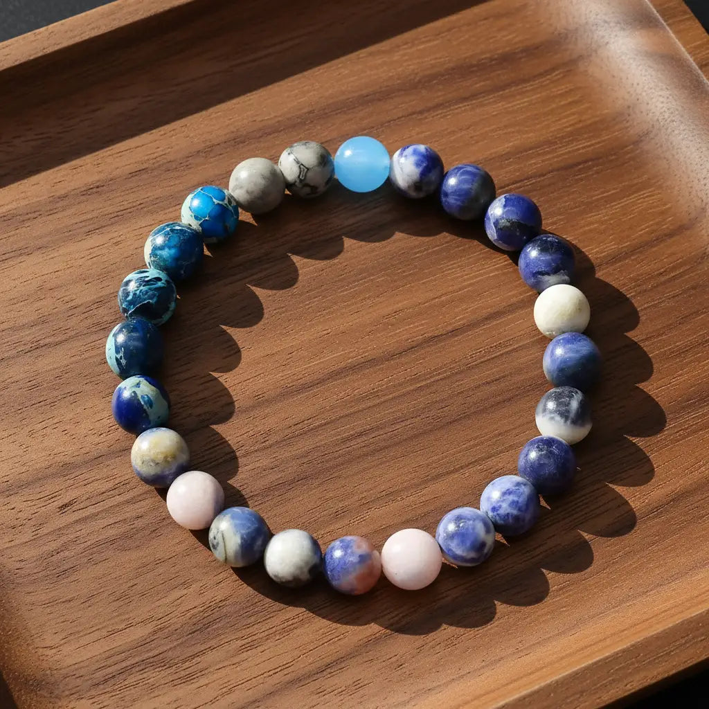 Close-up of multicolor blue beaded Earth Energy Crystal Bracelet on wooden tray | Oria Jewel