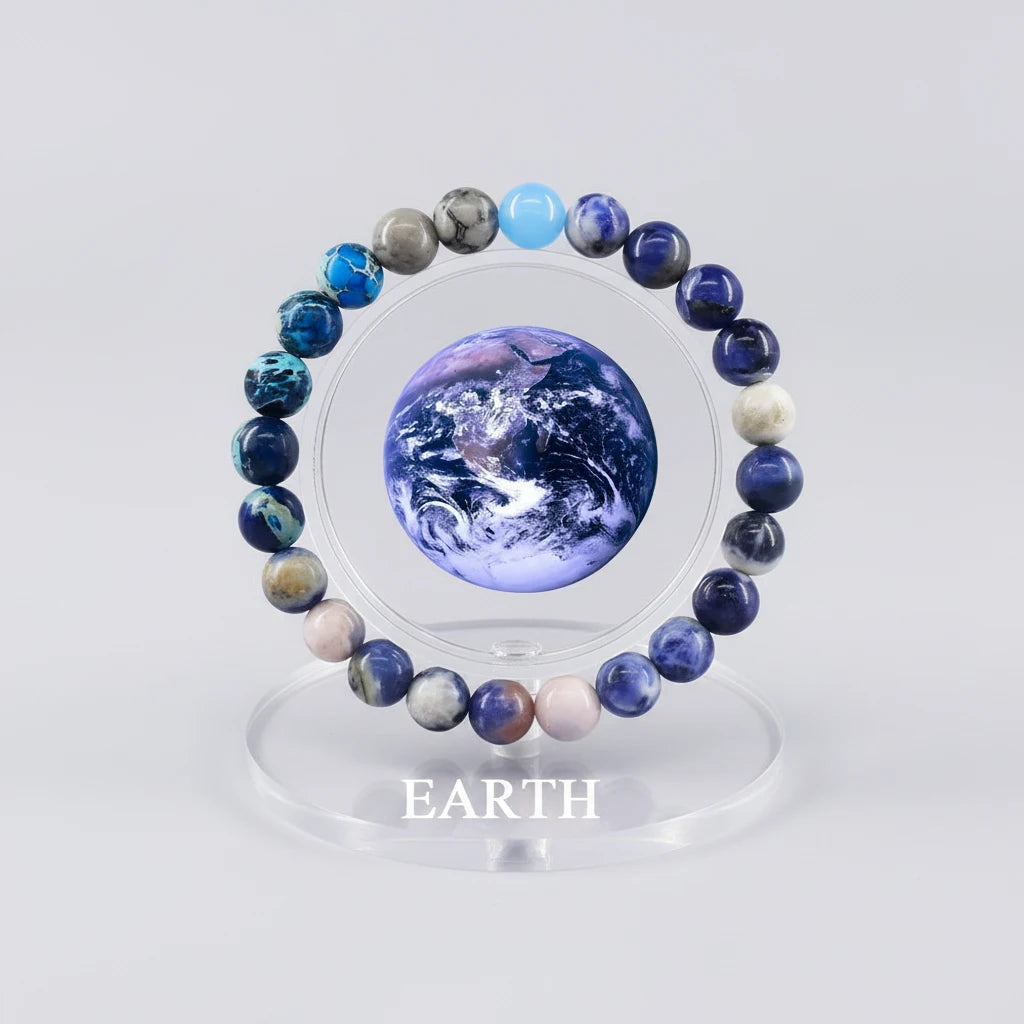 Earth Energy Crystal Bracelet displayed around planet Earth graphic on clear acrylic stand | Oria Jewel