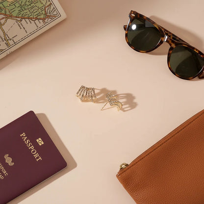 Fan Ear Cuff Earrings flat lay with passport, sunglasses, and pouch | OriaJewel