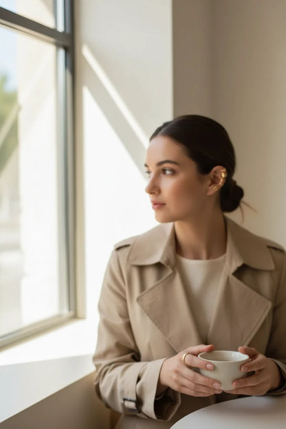 Gold 5-Piece Ear Cuff Set worn on model holding coffee by window | OriaJewel