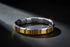 Dramatic studio close-up of Gold Center Stainless Steel Stretch Bracelets resting in a circular shape on a dark textured surface, with a spotlight highlighting the contrast between the brushed gold center links and polished silver edges | Oria Jewel