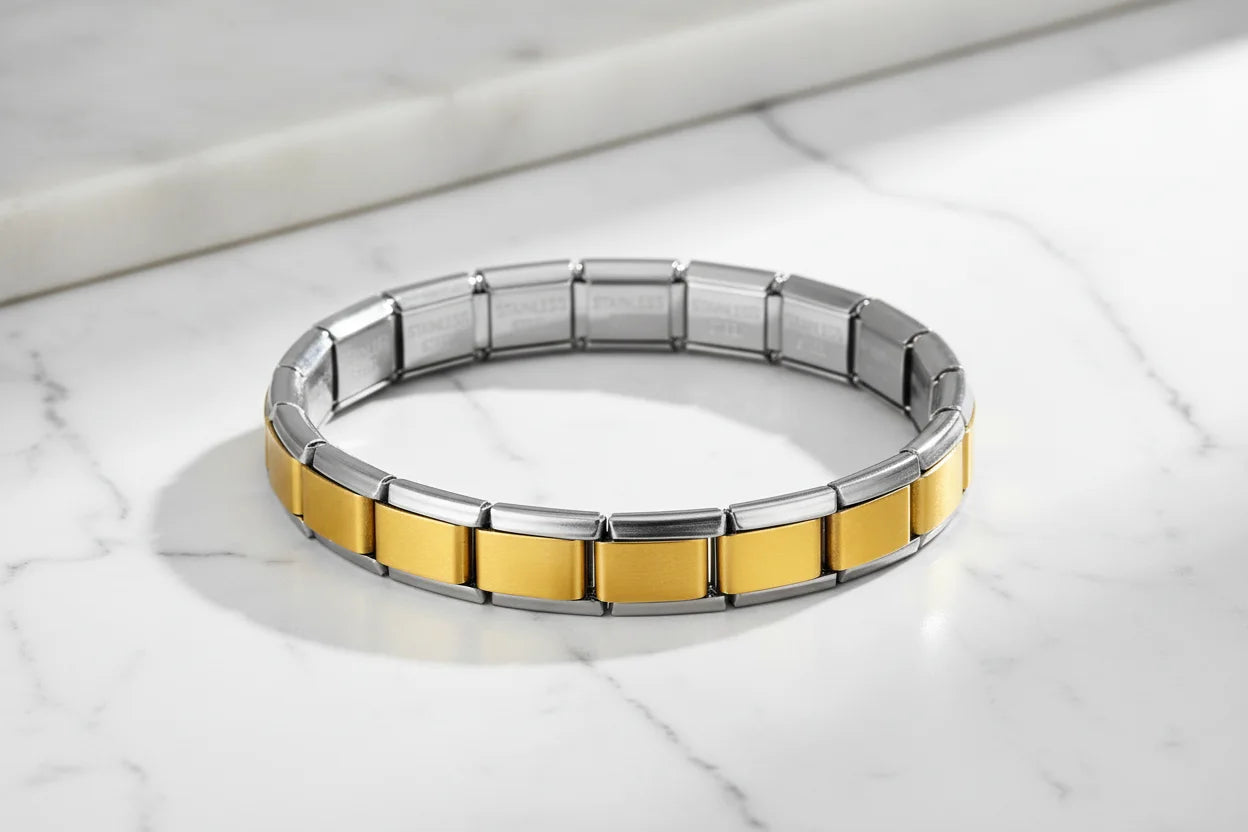 Minimalist product shot of Gold Center Stainless Steel Stretch Bracelets displayed in a perfect circle on a white marble surface, bright natural light emphasizing the sleek silver frame and satin gold panels | Oria Jewel