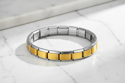 Minimalist product shot of Gold Center Stainless Steel Stretch Bracelets displayed in a perfect circle on a white marble surface, bright natural light emphasizing the sleek silver frame and satin gold panels | Oria Jewel