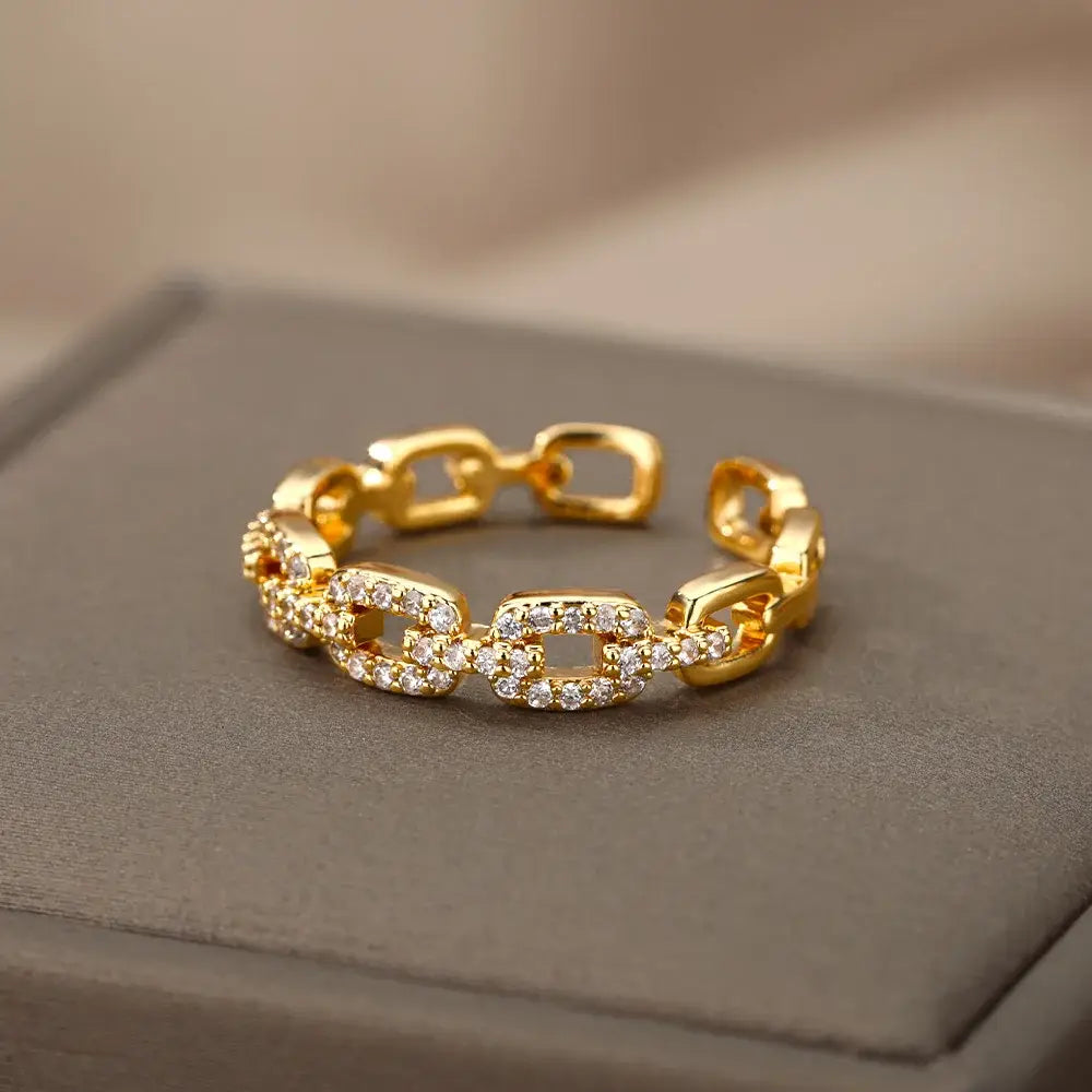 Gold Chain Link Ring displayed on a gray jewelry box, focus on three pavé crystal links and chunky high-polish chain segments | OriaJewel