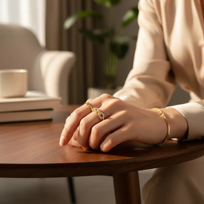 Gold Chain Link Ring on a hand resting on a wooden table, cozy home scene with soft daylight, highlighting pavé links and gold shine | OriaJewel