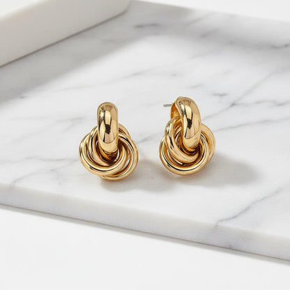 Gold Chunky Knot Stud Earrings pair on marble surface close-up | OriaJewel